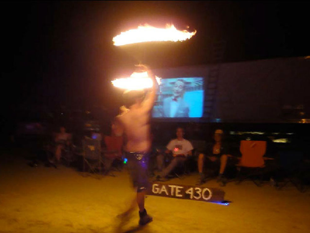 Fire performer in front of our 50-foot trailer "movie screen"