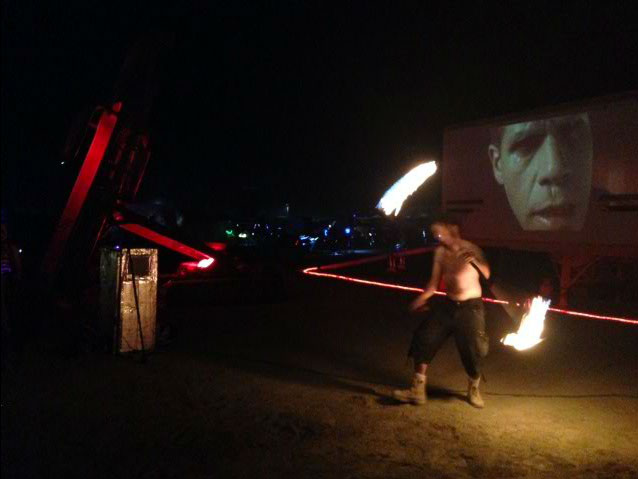Fire spinning with movie in background